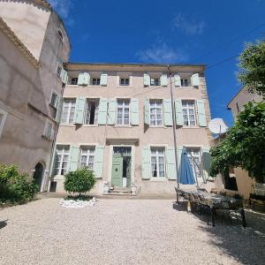 a large building with a bench in front of it at Occ34 - Capestang - Manoir in Capestang