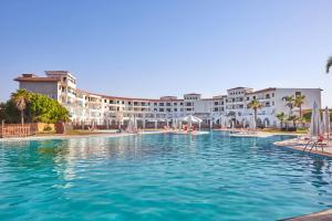 a swimming pool in front of a resort at Golden Palace Marina Hotel in El Alamein