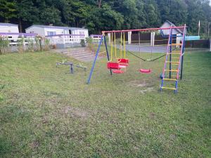 a playground with a slide in a yard at Lawendowa Przystań WICKO 3 km od Międzyzdrojów in Międzyzdroje