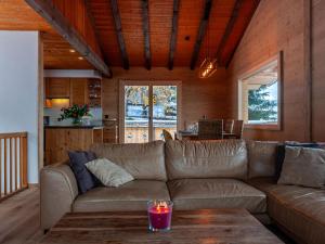 a living room with a couch and a table at Chalet Le Loup- le Renard et la Belette by Interhome in Nendaz
