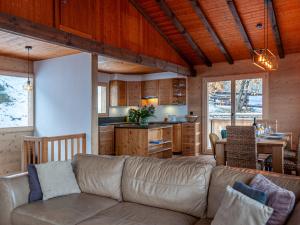 a living room with a couch and a kitchen at Chalet Le Loup- le Renard et la Belette by Interhome in Nendaz