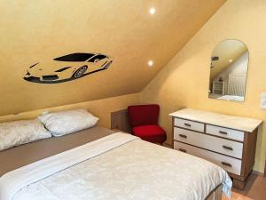 a bedroom with a bed and a car on the wall at Apartment Winona by Interhome in Wanna