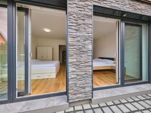 a room with large windows and a bedroom at Apartment Trendy Mountain Terrace Retreat by Interhome in Svoboda nad Úpou
