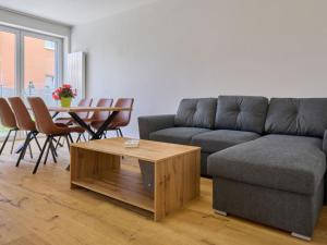a living room with a couch and a table at Apartment Trendy Mountain Terrace Retreat by Interhome in Svoboda nad Úpou +21 photos