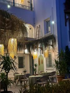 a courtyard with tables and chairs in front of a building at Andoya Butik Pansiyon in Bodrum City