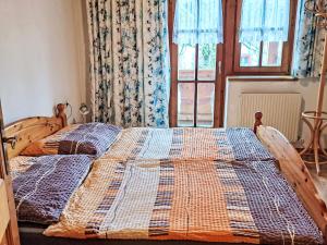 a bed with a quilt on it in a bedroom at Apartment Nicole by Interhome in Maishofen +13 photos