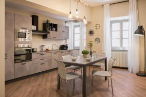 a kitchen with a table and chairs in a room at Ars Nova in Cuneo
