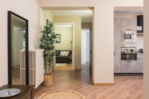 a living room with a couch and a kitchen at Ars Nova in Cuneo