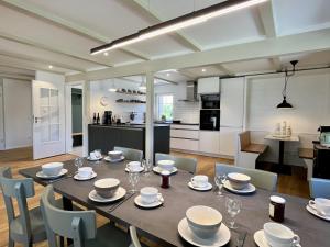 a dining room with a table and chairs and a kitchen at Holiday Home Melvill by Interhome in Dittishausen