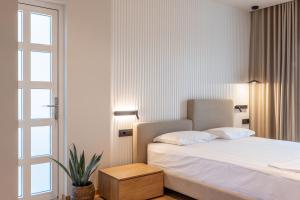 Postel nebo postele na pokoji v ubytování Kamara Rooms