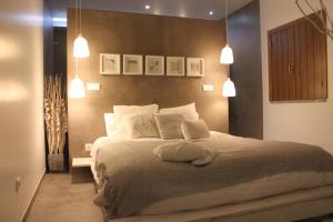a bedroom with a large bed with white pillows at Terras - Agroturismo & Vinhos in Beja +45 photos