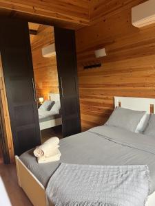 a bedroom with two beds and wooden walls at Casa en Port del Comte mínimo 31 días in La Coma i la Pedra +50 photos