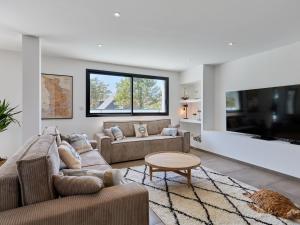 a living room with two couches and a tv at Holiday Home Denneweiller by Interhome in Denneville