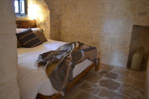 Postel nebo postele na pokoji v ubytování B&B Fuga al Trullo