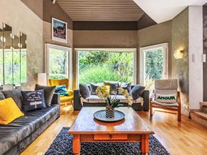 a living room with a couch and a table at Holiday Home Maison de Locmaria by Interhome in Ploemel