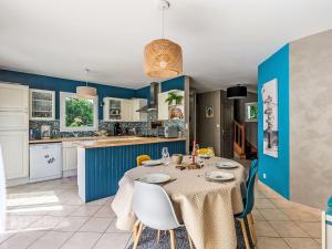 a kitchen and dining room with a table and chairs at Holiday Home Maison de Locmaria by Interhome in Ploemel +16 photos