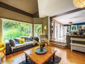 a living room with a couch and a table at Holiday Home Maison de Locmaria by Interhome in Ploemel