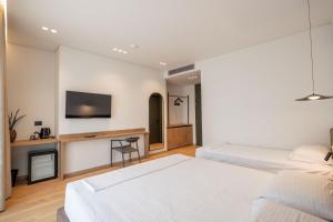 Postel nebo postele na pokoji v ubytování Kamara Rooms