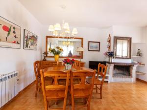 a dining room with a wooden table and chairs at Holiday Home Salze by Interhome in Hospitalet de l'Infant