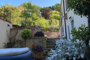 a view of a garden with plants and a building at The Nest in Gloucestershire