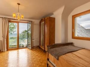 a bedroom with a bed and a large window at Holiday Home Brise Marine by Interhome in Cancale