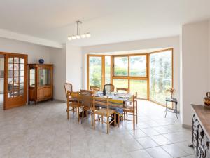 a dining room with a table and chairs at Holiday Home Brise Marine by Interhome in Cancale +27 photos