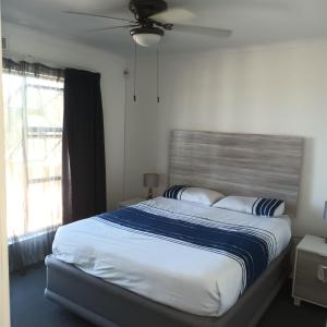 a large bed in a bedroom with a window at Ramsgate Beachfront - Ramsgate Palms AA 50 in Margate