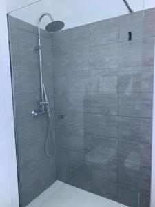 a bathroom with a shower with a glass door at Bilocale nuovo - Basiglio Humanitas in Basiglio +32 photos