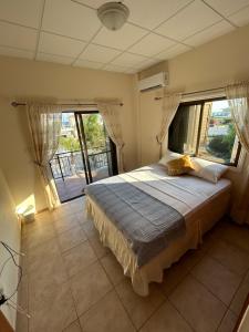 a bedroom with a large bed with a large window at Ayia Napa Marina Luxury Villas - Diamond in Ayia Napa +25 photos