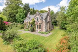 an old house with a garden in front of it at Gardener's Cottage in Crieff