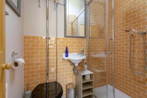 a bathroom with a glass shower and a sink at Gardener's Cottage in Crieff +31 photos