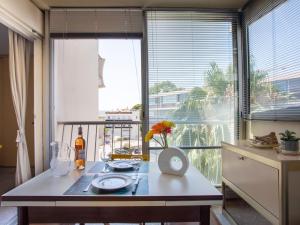 a kitchen with a table and a large window at Apartment Azur 3000 by Interhome in Saint-Laurent-du-Var