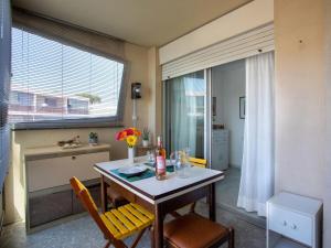 a dining room with a table and chairs and a window at Apartment Azur 3000 by Interhome in Saint-Laurent-du-Var