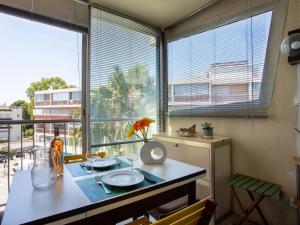 a dining room with a table and a large window at Apartment Azur 3000 by Interhome in Saint-Laurent-du-Var