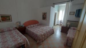 Postel nebo postele na pokoji v ubytování Albergo Regina
