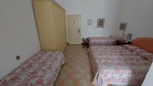 Postel nebo postele na pokoji v ubytování Albergo Regina