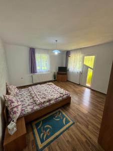 a bedroom with a bed in the middle of a room at Casa Eliza in Ocna Şugatag