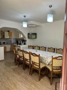 a dining room with a table and chairs at Casa Eliza in Ocna Şugatag