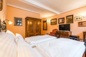 En eller flere senger på et rom på Hotel Leonardo