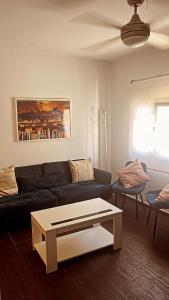 a living room with a couch and a coffee table at Apartamento de la Cruz in Merida