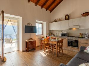 a kitchen and dining room with a table and chairs at Apartment Home2Sunrise by Interhome in Cremia
