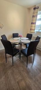 a dining room with a table and chairs at Eastpark 5 bdrms Walk to O2 Apollo and City in Manchester