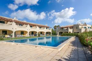 a swimming pool in the courtyard of a house at Casa Verão Azul - Porches in Porches