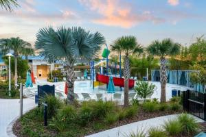 a resort with a playground with a slide and palm trees at 3787 Elegant 6BD Island Getaway Windsor Resort in Davenport
