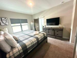 a bedroom with a bed and a television in it at 216 Oasis Magic 4BD Villa 5 Min to Disney Magic in Loughman +42 photos