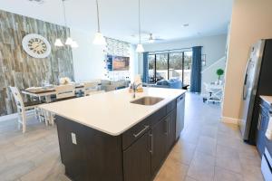 a kitchen with a sink and a dining room at 216 Oasis Magic 4BD Villa 5 Min to Disney Magic in Loughman