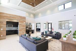 a living room with two couches and a table at 216 Oasis Magic 4BD Villa 5 Min to Disney Magic in Loughman