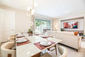 a dining room and living room with a table and chairs at 7992 Charming Disney Vacation Home - 5 Bd in Orlando
