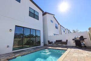 a swimming pool in front of a house at 216 Oasis Magic 4BD Villa 5 Min to Disney Magic in Loughman