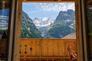 a view from a window of a mountain view at Boutique Hotel Panorama Grindelwald in Grindelwald